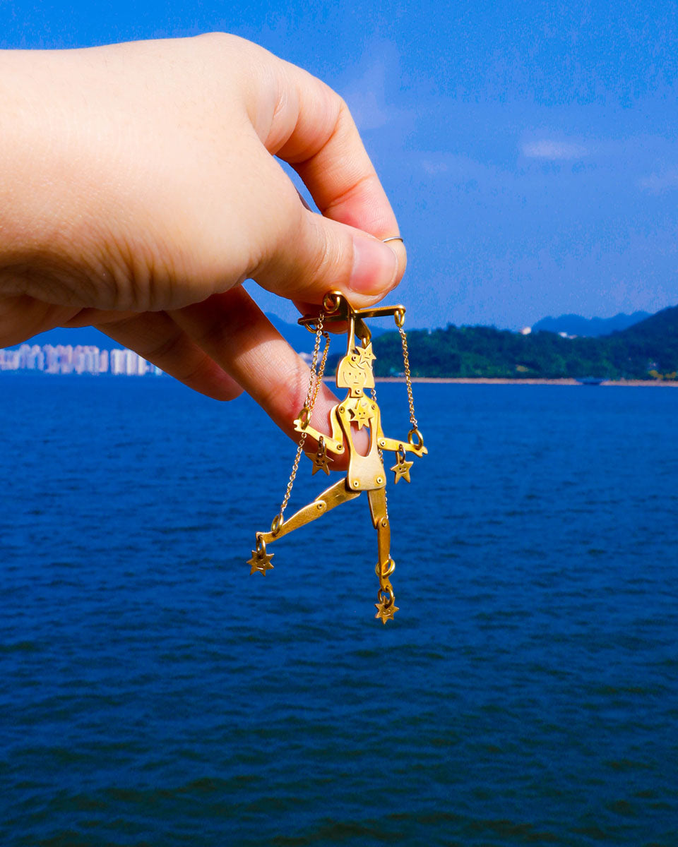 Mini articulated puppet earrings in brass, smaller version of “The Person Controlled By The Stars”, handmade sculptural jewelry