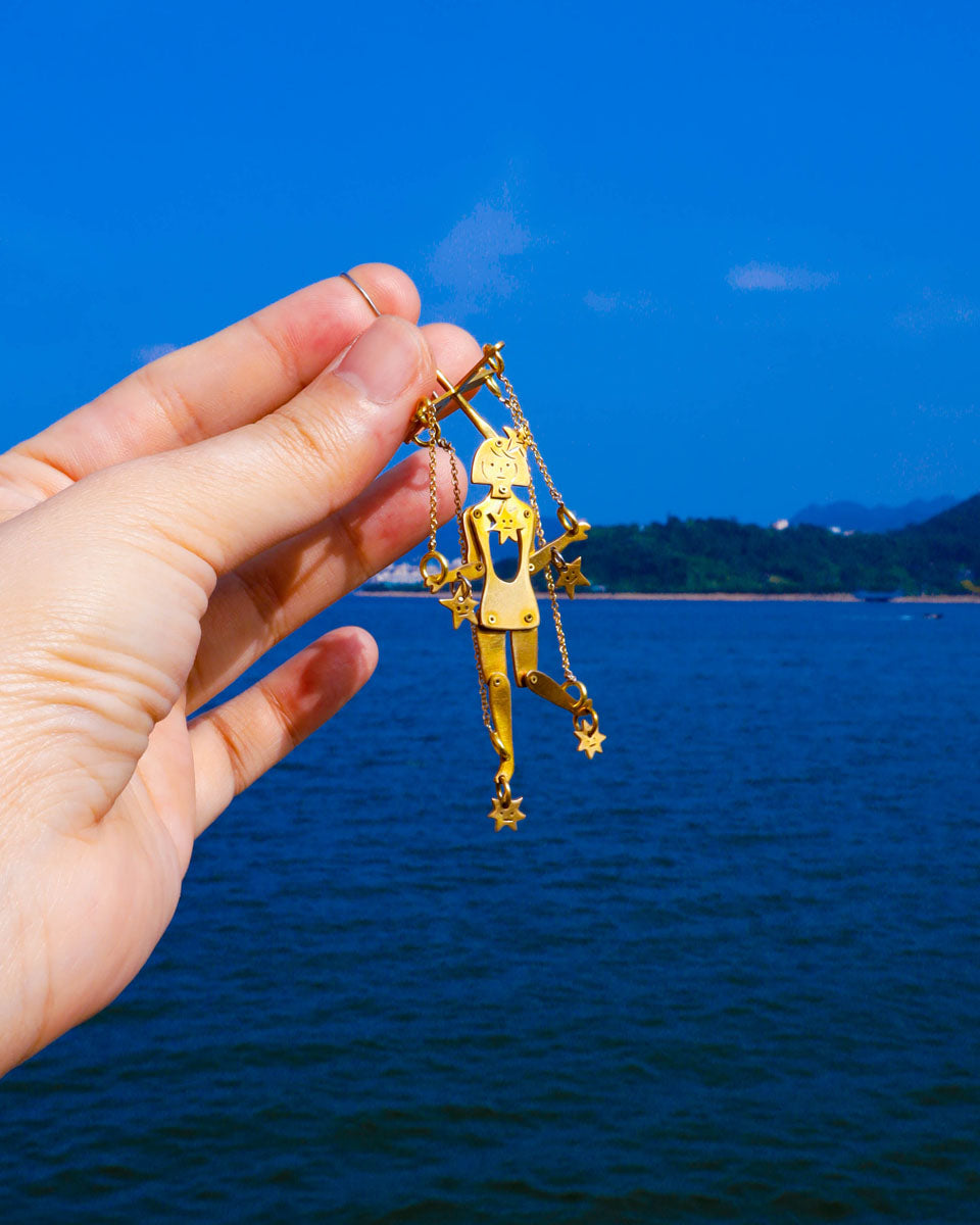 Mini articulated puppet earrings in brass, smaller version of “The Person Controlled By The Stars”, handmade sculptural jewelry