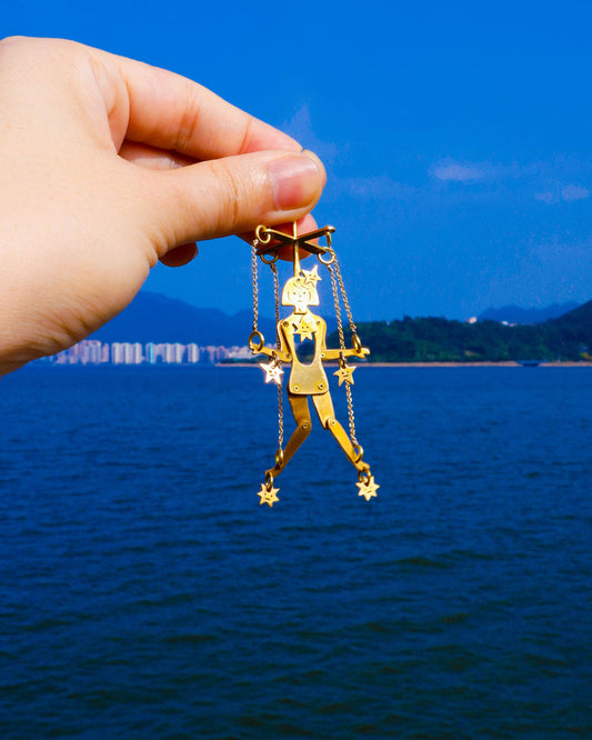 Handmade articulated puppet earrings in brass, “The Person Controlled By The Stars Mini”, sculptural statement jewelry with jointed moving parts