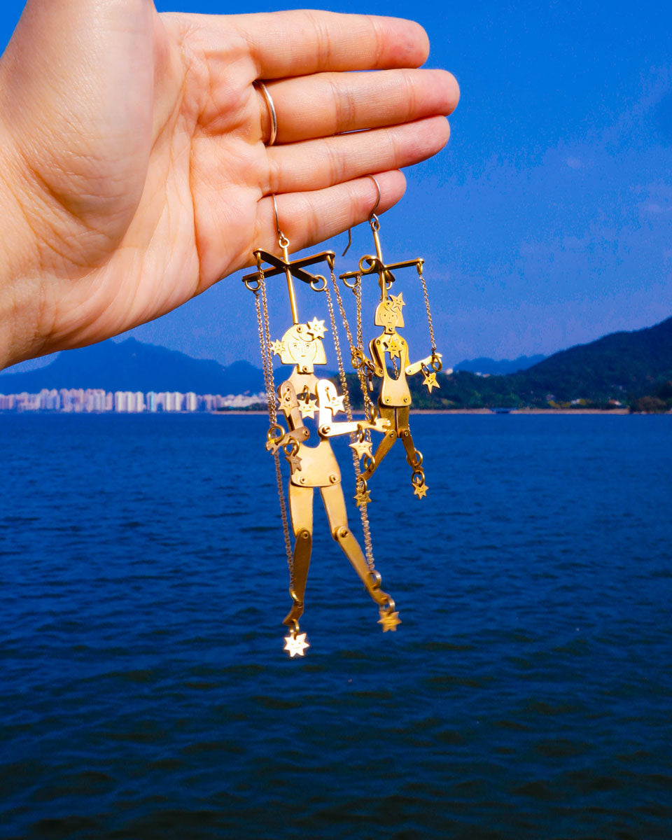Kinetic puppet earrings with moving joints in brass, handmade statement jewelry inspired by stars and extra-terrestrial