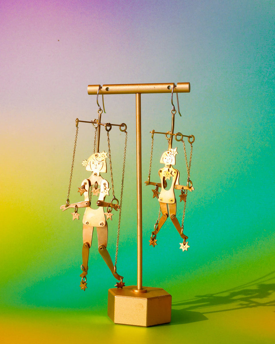 Handmade articulated puppet earrings in brass, “The Person Controlled By The Stars Mini” and "“The Person Controlled By The Stars", sculptural statement jewelry with jointed moving parts