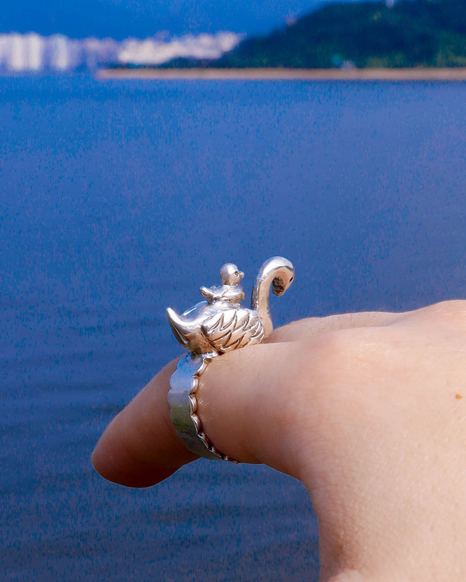 Sculptural sterling silver swan ring with cygnet perched on its back