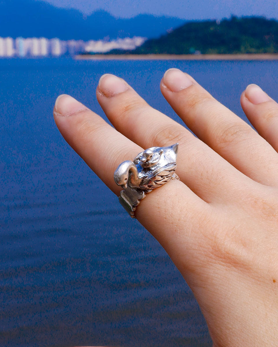 top view of a Sculptural sterling silver swan ring with cygnet perched on its back