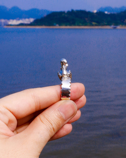 side view of Handmade swan ring in sterling silver photographed beside water