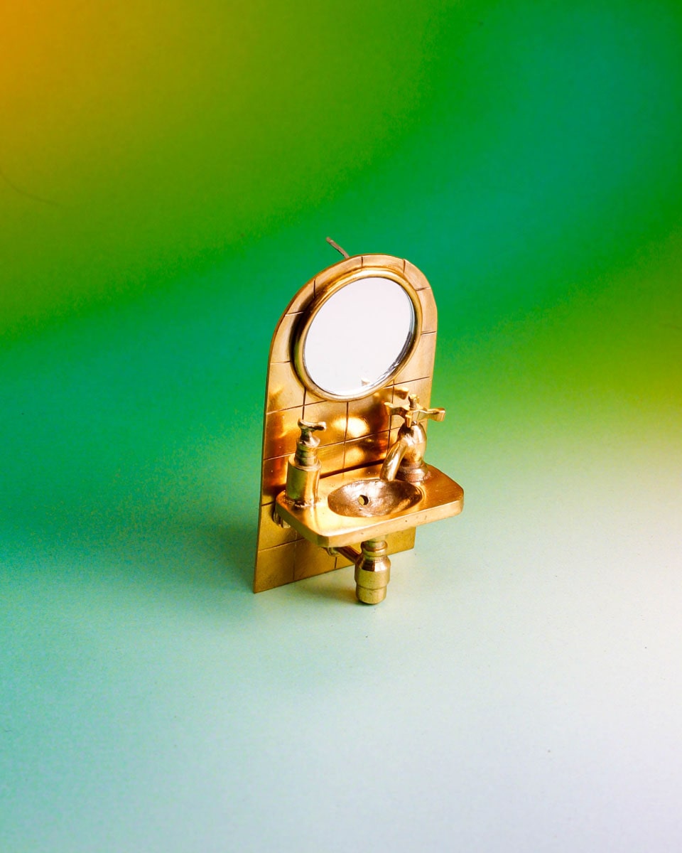 Wearable miniature sink art jewelry, handcrafted in brass