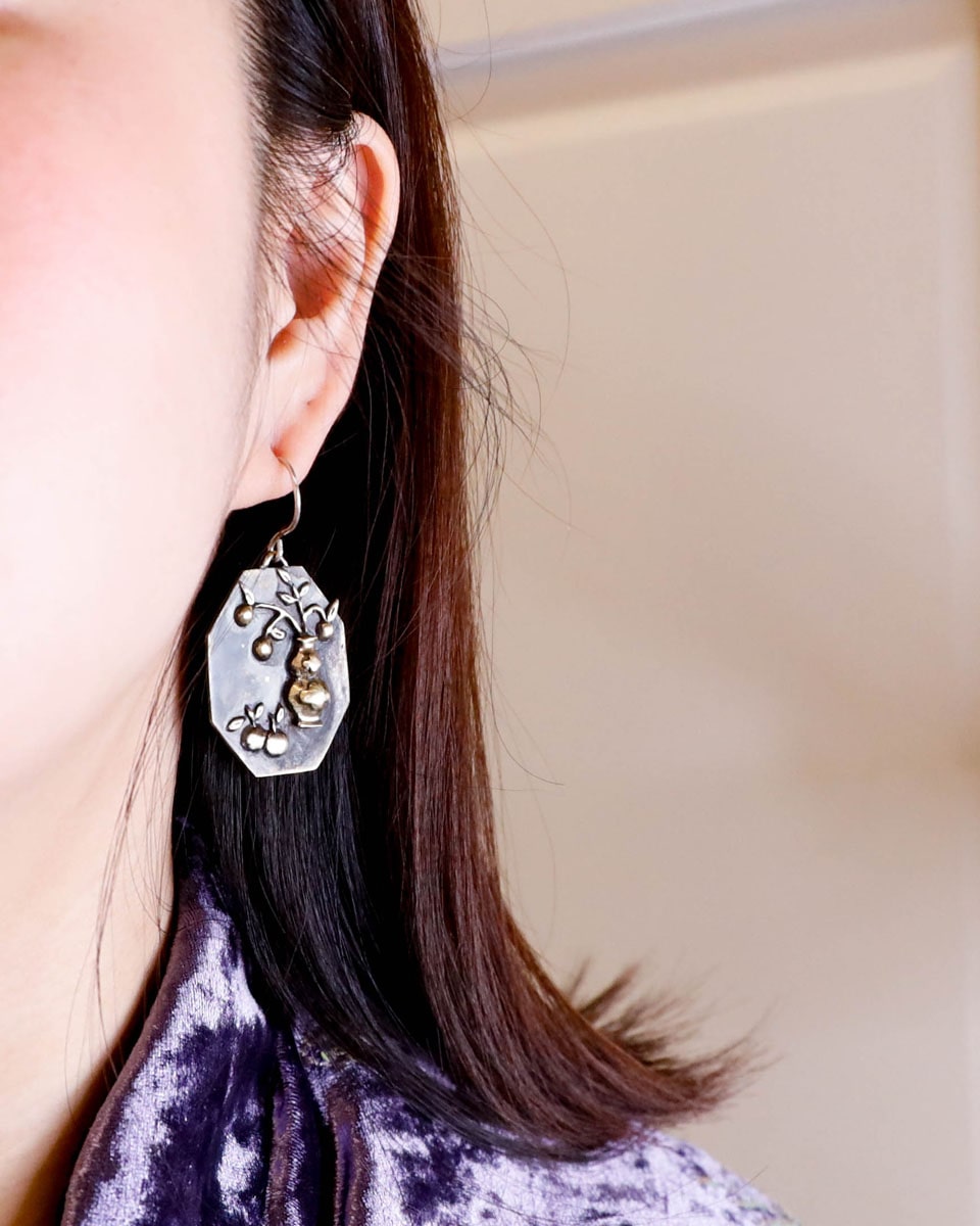 Handcrafted earrings inspired by tangerines, a Chinese symbol of good luck and prosperity for the Lunar New Year