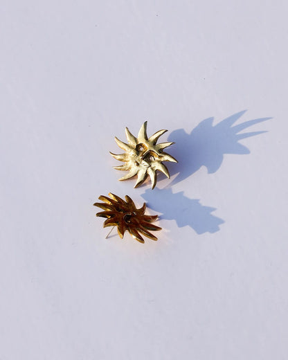 a pair of solid brass sun earrings, handmade studs