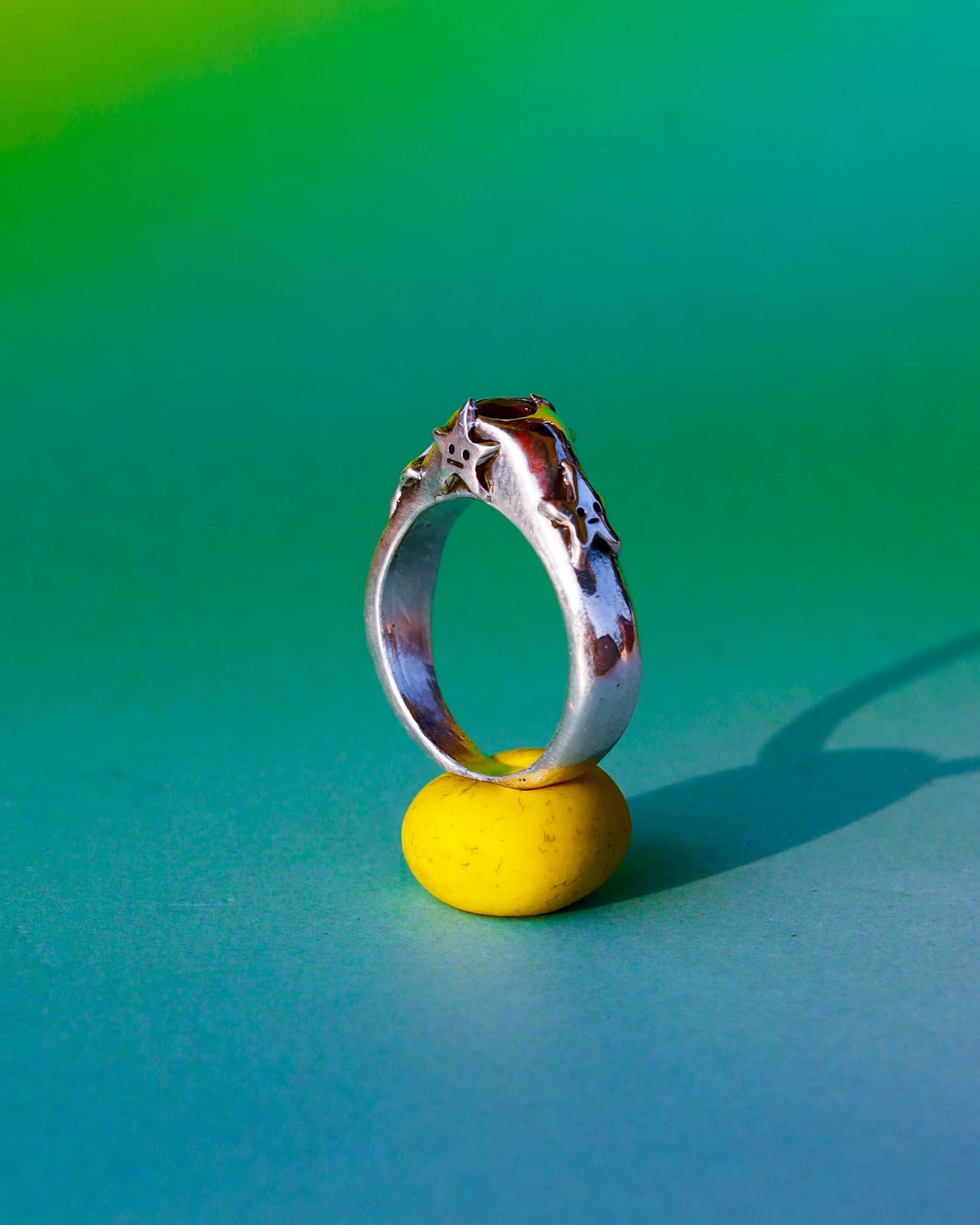 four stars sterling silver ring with a red garnet