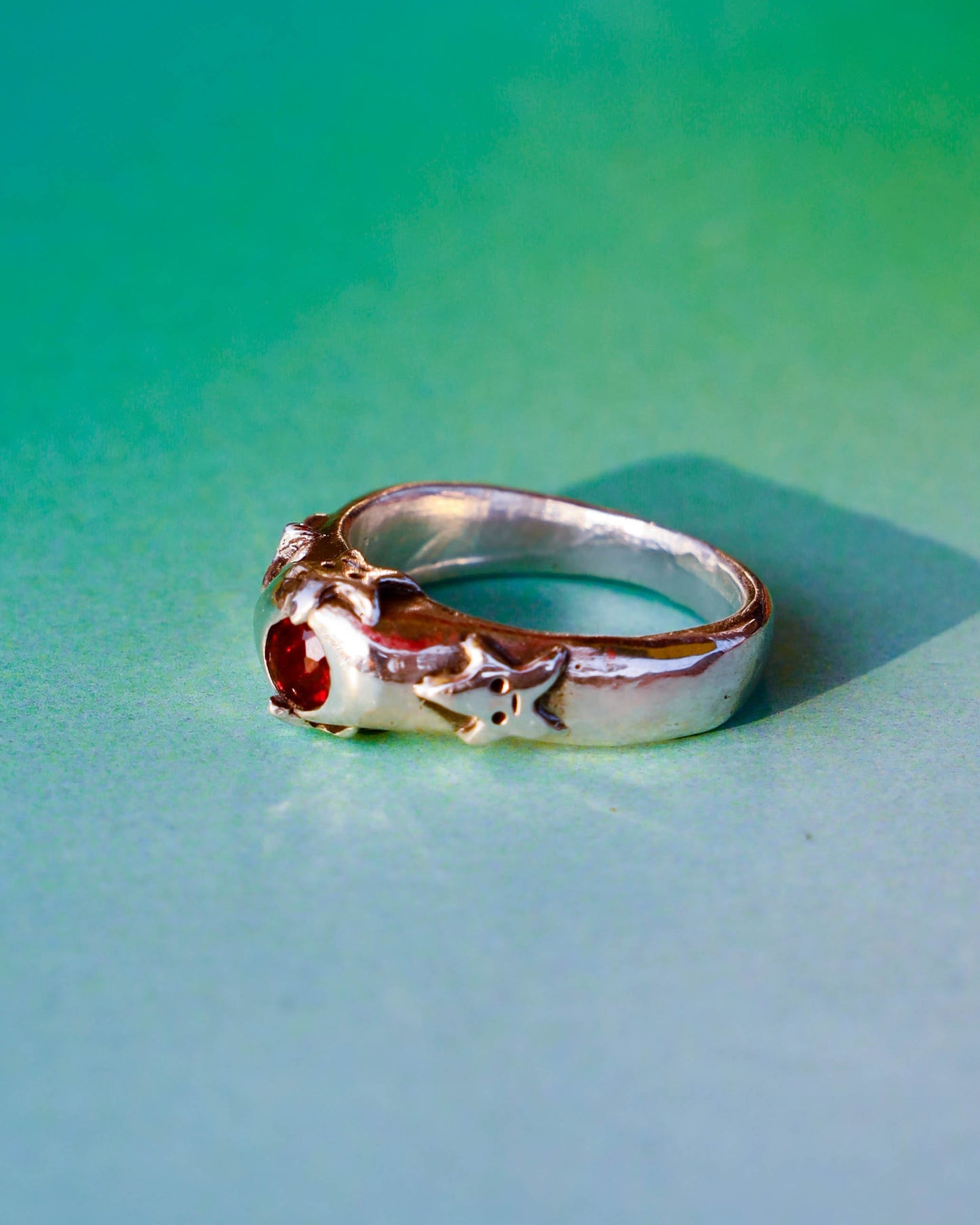 four stars sterling silver ring with a red garnet