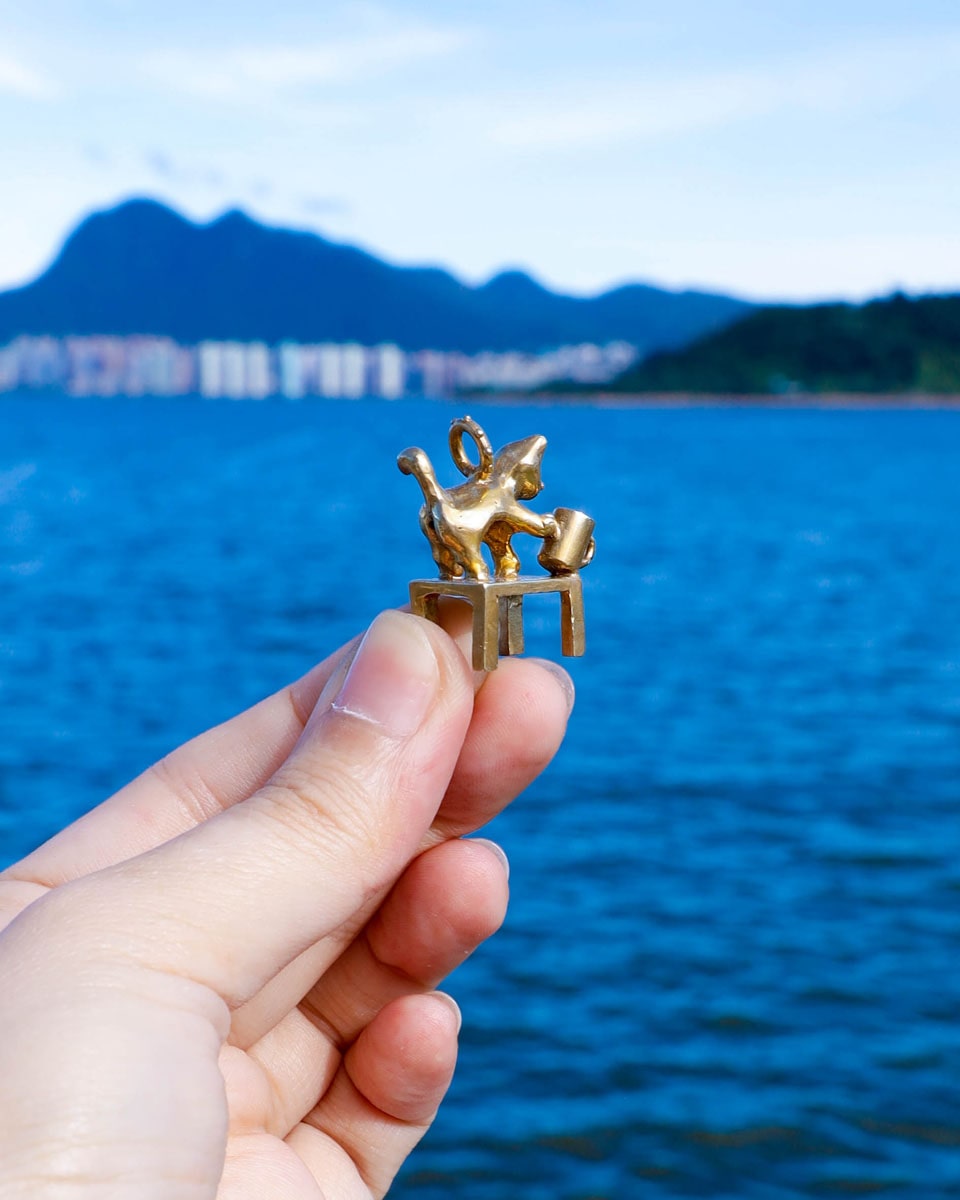 solid brass naughty kitty charm, cat pushing cup off table, set with cz stone, handmade jewellery, by fake plastic love