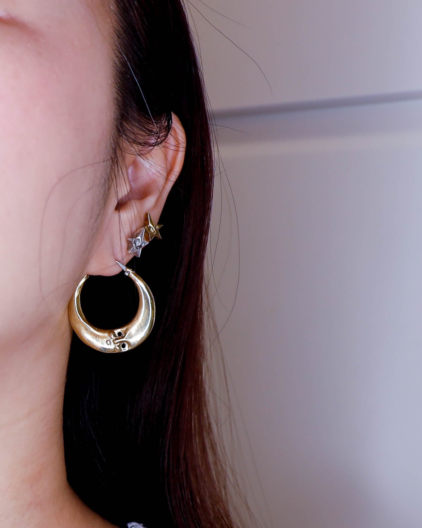 full moon hoop earring close up, handmade earring in solid brass and sterling silver
