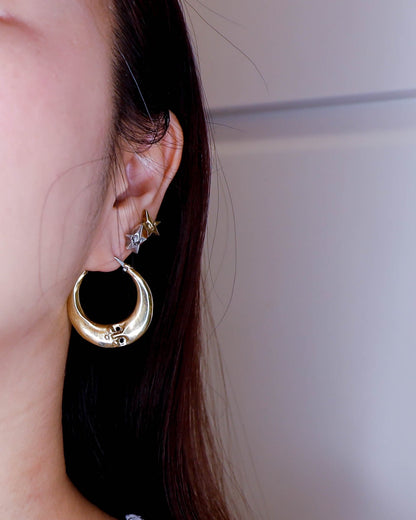 full moon hoop earring close up, handmade earring in solid brass and sterling silver