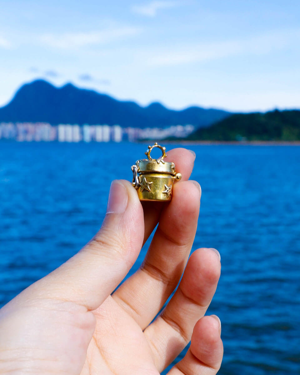 a solid brass locket with stars design, handmade small container locket pendant